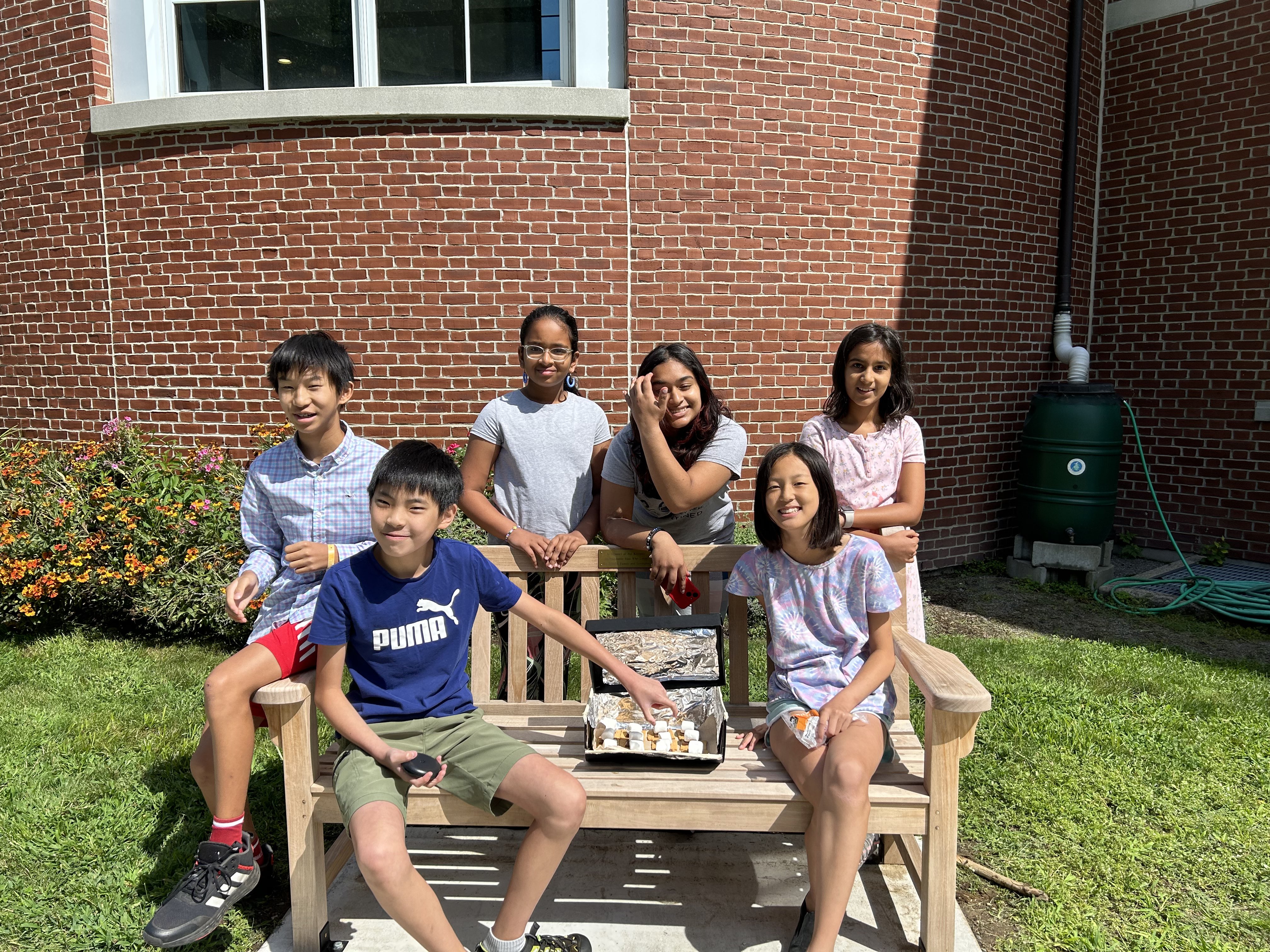 Students sitting on a bench, happy that they participated in Science Outdoors Season 3!